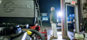 Man next to an Exmark mower