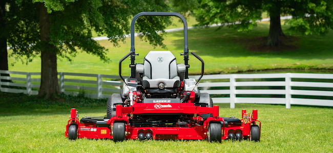 Exmark wide area mower on a fenced lawn