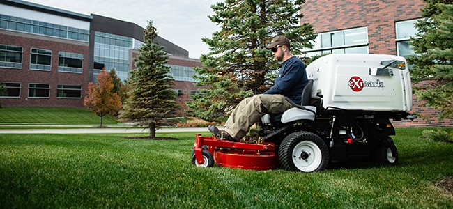 Exmark Navigator, a performance mower with RED technology and EFI, mowing an office campus